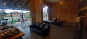 a living room with a leather chair and a table at Suiteness Deir el qamar in Dayr al Qamar