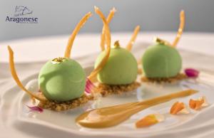 a white plate with three green desserts on it at Hotel Villa Durrueli Resort & Spa in Ischia