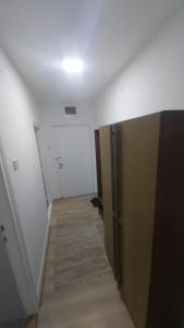 a hallway of an empty room with a door and a hallway at Apartman Pavlovic in Leskovac