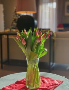 a vase filled with flowers on top of a table at LA Hotel in Lidingö