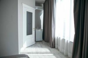 a white room with a door and a window at Hotel Lux in Makhachkala