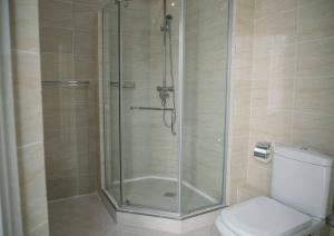 a shower stall in a bathroom with a toilet at Hotel Lux in Makhachkala