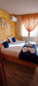 a bedroom with two beds and a window at Guest House Edelweiss in Govedartsi