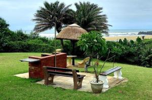 a gazebo with a picnic table and a bench at Ocean Breeze 23 in Kingsborough