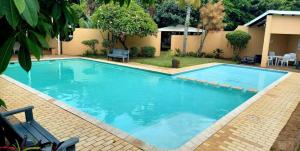 a large pool with blue water in a yard at Ocean Breeze 23 in Kingsborough