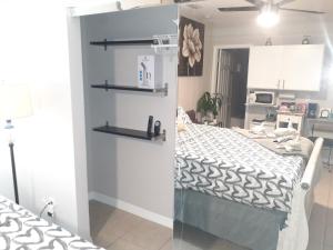 a bedroom with a bed and a kitchen at LUXURIOUS COZY STUDIO. in Tampa