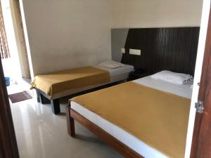 two beds in a room with two beds sidx sidx sidx at Star Residency in Mysore