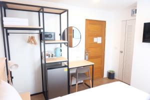 a small room with a desk and a closet at B3 HOUSE in Kamala Beach