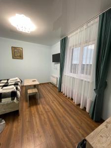 Sukhostav的住宿－Готель ТІК Копичинці，客房设有床、桌子和窗户。