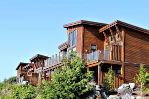 a large wooden house with balconies on a hill at Luxurious Top Floor Villa With Sweeping Pacific Ocean - Bbv in Ucluelet