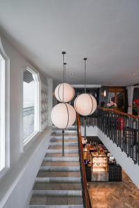 a staircase with pendant lights in a house at The Lantern Hatyai Hotel in Hat Yai