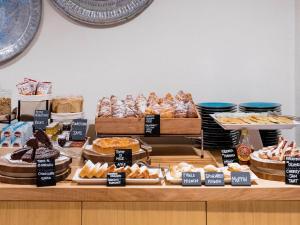 a bakery counter with different types of bread and pastries at Cumeja Beach Club & Hotel in Baia Domizia