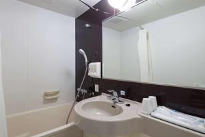 a bathroom with a sink and a mirror at Comfort Hotel Tsubamesanjo in Sanjo