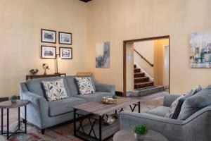 a living room with two couches and a table at Historic Sonora Inn in Sonora