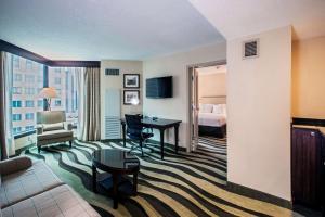 a hotel room with a bed and a desk in a room at Fort Pontchartrain Detroit, a Wyndham Hotel in Detroit