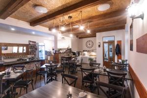 a restaurant with wooden ceilings and tables and chairs at Penzion Královské lázně in Poděbrady