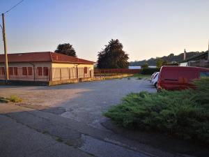 a parking lot with a van parked next to a building at Bilocale Francesca in Erba