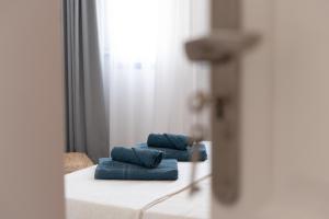 two blue towels sitting on top of a bed at La Pardela Excellence Apartamentos in Caleta de Sebo +121 photos