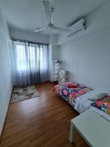 a bedroom with two beds and a ceiling fan at HOMESTAY @ BANDAR SERI PUTRA KAJANG in Kajang