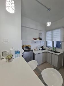 a kitchen with a table and two chairs in it at HOMESTAY @ BANDAR SERI PUTRA KAJANG in Kajang