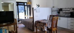 a kitchen with a refrigerator and a bed in a room at Casa de Isora Private apartments in Garachico