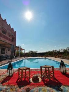 two chairs sitting next to a swimming pool at villa darga rouge in Marrakech