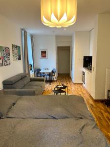 a living room with a couch and a table at Zentrale Ferienwohnung mit Balkon in Aachen in Aachen