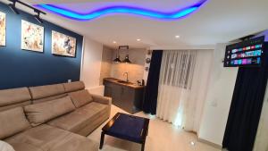 a living room with a couch and a tv on the ceiling at Hotel ULYSSES in Mtskheta