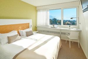Voodi või voodid majutusasutuse Le Leman Hotel toas