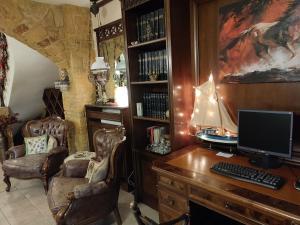 a home office with a desk with a computer on it at British Wood 'n Stone House in Thessaloniki
