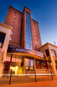 a large building with a sign on the front of it at Eurosol Residence in Leiria