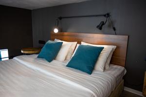 
a bed with white sheets and pillows in a bedroom at MIO Apartments in Adler
