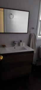 a bathroom with a white sink and a mirror at Apartamento rural castril in Castril