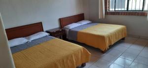 a room with two beds and a window at Villas del monteón in Monteón +55 photos