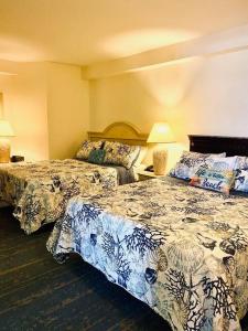 a hotel room with two beds and two lamps at Spectacular Ocean View in Daytona Beach