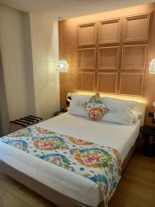 a bedroom with a large bed with a wooden headboard at La Puerta de Nerja BOUTIQUE - Adults Recommended in Nerja