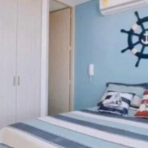 1 dormitorio con 1 cama con pared azul en Apartamento Vacacional para Familias en Pozos Colorados Santa Marta, en Santa Marta