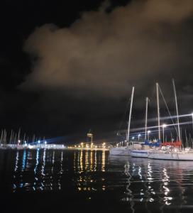 two boats are docked in the water at night at Beamar in Valencia