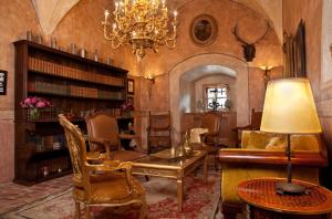 a living room filled with furniture and a chandelier at Schloss Matzen in Reith im Alpbachtal