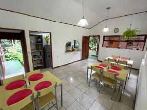 a dining room with yellow tables and red chairs at Dreams Lodge in Monteverde Costa Rica