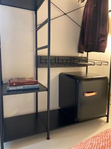 a black bunk bed with a ladder and a shelf at Casimiro Rooms in Cesena +56 photos