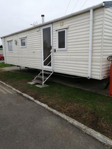 a white trailer with a door open on the side at 707 Seawick in Jaywick Sands