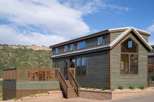 a house with a deck and a mountain in the background at Jellystone Park™ at Larkspur in Larkspur +14 photos