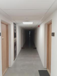 a hallway in an office building with a long corridor at Róża- Lotnisko in Wrocław