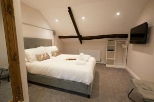 a hotel room with a bed and a television at Three Cranes Boutique Hotel in Sheffield