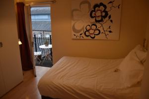 a bedroom with a bed and a view of a table at Scandinavian City Centre Apartment in Worcester