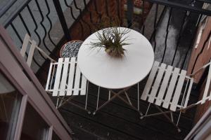 a white table and two chairs on a balcony at Scandinavian City Centre Apartment in Worcester