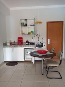a kitchen with a table with a red bowl on it at APARTAMENTO ÁGUAS DA SERRA - 005b in Rio Quente