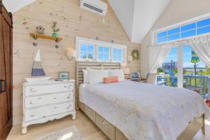 a bedroom with a bed and a wooden wall at Plovers Nest in Newburyport