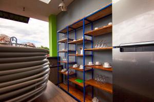 a room with plates on shelves in a kitchen at RAP Hotel Balige in Balige